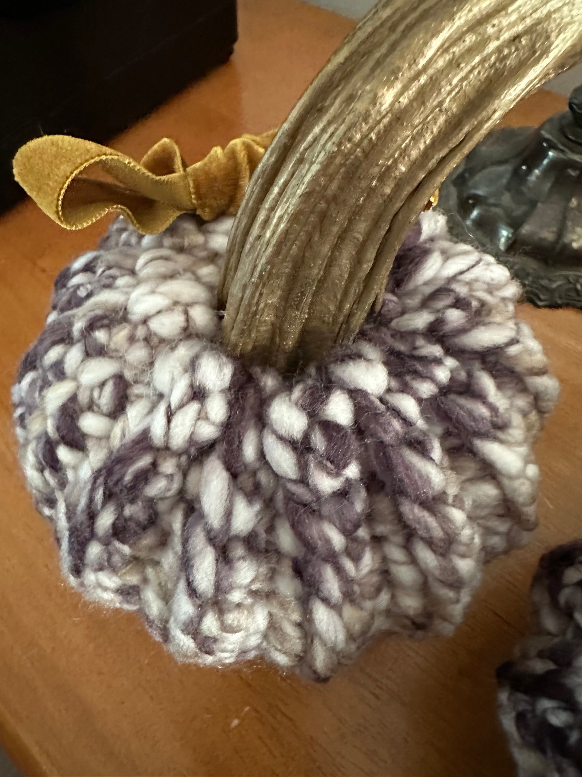 crochet pumpkin with gold painted stem and velvet ribbon