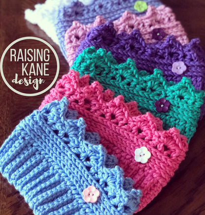 Colorful crocheted headbands with buttons on a wooden surface, featuring 'Raising Kane Design'.