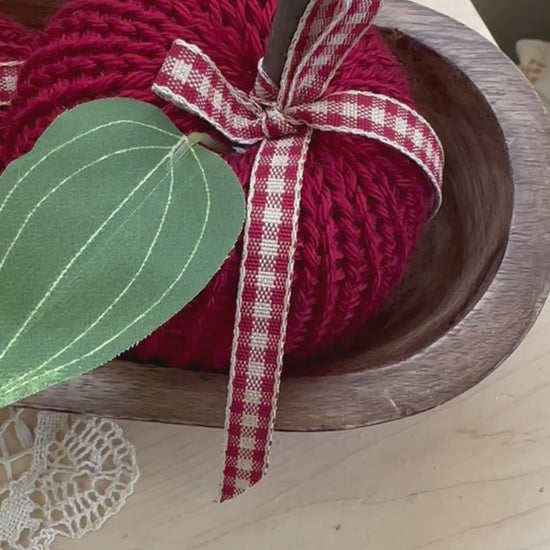 knit apple with green leaf and wood stem and green faux leaf
